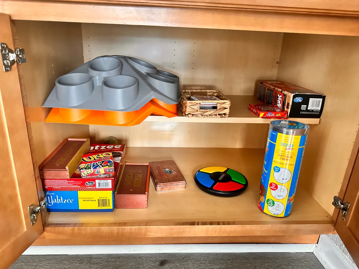 A close-up view of various board games and colorful accessories set out on a table, ready for a fun and memorable game night. The scene radiates playfulness and the simple joys of spending time together indoors.